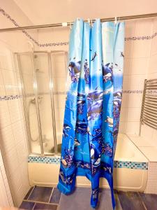 uma cortina de chuveiro na casa de banho com uma cabina de duche em E-Sky Homes em South Norwood