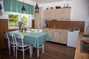 a kitchen with a table with a green and white table cloth at Zeleni brig in Mrkopalj