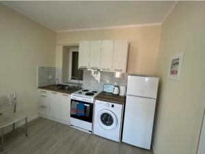 a kitchen with a white stove and a refrigerator at Anmare Studios in Nydri