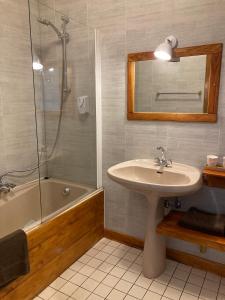 a bathroom with a sink and a shower and a tub at Auberge de France in Kruth