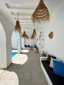 a living room with a couch and a swimming pool at Villa Sans Vis à Vis Le Domaine Luxury Experience in Mezraya