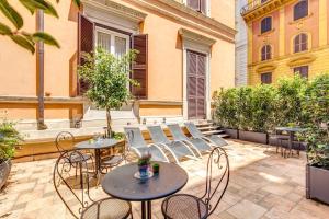 a patio with tables and chairs in a courtyard at Manin Suites LT in Rome
