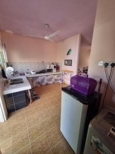 a kitchen with a sink and a counter top at Umar's Tiny House in Kampong Kemaman