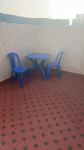 two blue chairs and a table in a room at BLUE RIAD in Safi