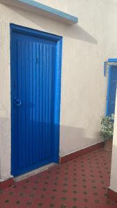 a blue door on the side of a building at BLUE RIAD in Safi