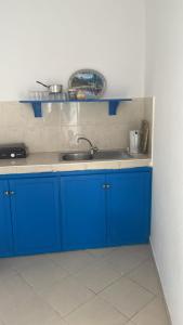 a kitchen with blue cabinets and a sink at BLUE RIAD in Safi
