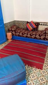 a living room with a couch and a rug at BLUE RIAD in Safi