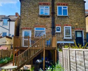 a wooden deck in front of a brick building at E-Sky Homes in South Norwood