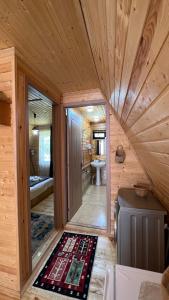 a small room with a bathroom in a log cabin at Cottage Mida in Mestia