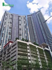 two tall buildings with plants growing on them at The Ooak Suites by Bamboo Hospitality in Kuala Lumpur