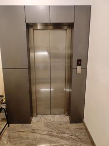 an elevator in a building with a metal door at MITRA HOTELS in Mysore