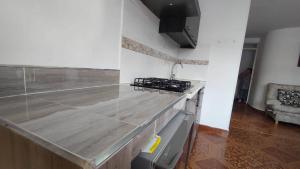 a kitchen with a marble counter top in a room at Apartamento Turistico Centenario in Montenegro