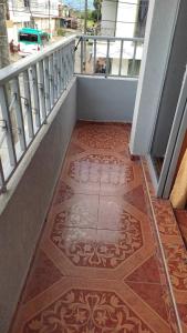 a balcony with a tile floor on a building at Apartamento Turistico Centenario in Montenegro