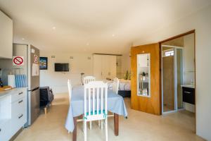 a kitchen and dining room with a table and chairs at Danville Forest Villa in Durban