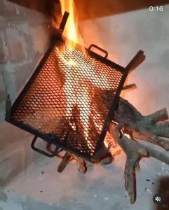 a fire is burning in a stove at A Morriña in Santa Lucía