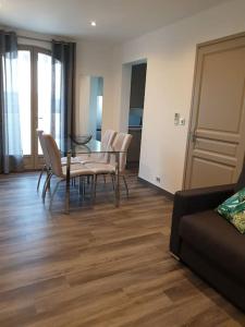 - un salon avec une table, des chaises et un canapé dans l'établissement F2 tout confort avec vue panoramique, à Bastelicaccia