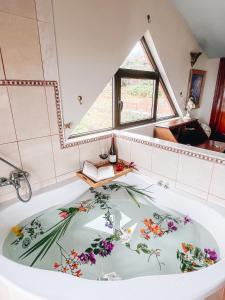 a large bath tub with flowers painted on it at Sun-soaked apt w patio, balcony & garden - Aguilas in La Orotava
