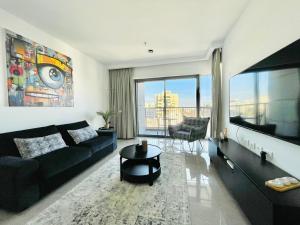a living room with a couch and a table at Savion View Apartment - Jerusalem City Center in Jerusalem