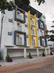 a building with yellow and blue balconies on it at MITRA HOTELS in Mysore