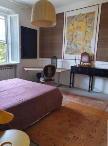 una camera con letto, scrivania e pianoforte di Villa Eclettica A POCHI METRI DAL MARE a Pesaro