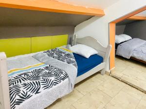 1 Schlafzimmer mit 2 Betten und 1 Etagenbett in der Unterkunft Maison et sa dépendance ss voisinage dans les vergers de Montmorency in Saint-Brice-sous-Forêt