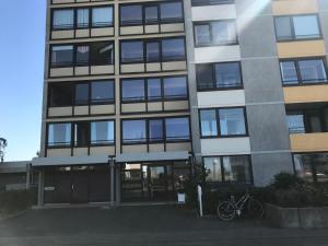 a bike parked in front of a building at Appartment direkt am Marina Wendtorf mit Seeblick in Wendtorf +4 photos
