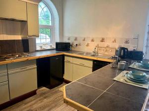 a kitchen with a sink and a counter top at Stunning Cottage in Kilmun Argyll - sleeps 2 in Dunoon