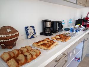 a counter with several different types of bread on it at Nayah Stays, Amazing villa with private pool & 5 master suites in Hurghada