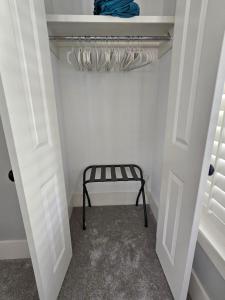 a walk in closet with a bench in a room at Low Country Cottage in Beautiful Habersham in Beaufort