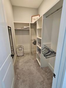 a walk in closet with white shelving at Low Country Cottage in Beautiful Habersham in Beaufort