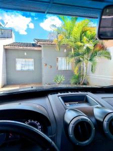 a view of a house from the inside of a car at Casa aconchegante. in Campo Grande