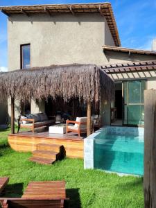 a villa with a swimming pool and a resort at Casa Prainha in Praia do Frances