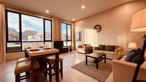 een woonkamer met een tafel en een bank bij ONE 2BHK Apartments in Muscat