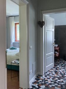 a room with a door leading to a bedroom at Maison Montello in Varese