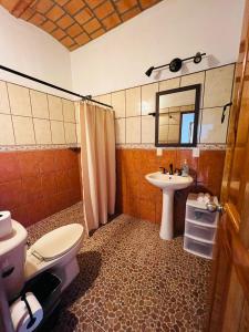 a bathroom with a toilet and a sink at Paraiso Escondido in Lo de Marcos +16 photos