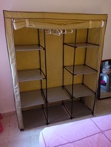 a cupboard with shelves in a room at Habitacion de matrimonio en Castilleja de la Cuesta in Castilleja de la Cuesta