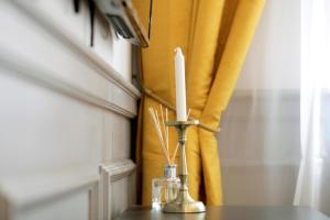 a candle in a vase on a table at Central Boutique Apartments in Sighişoara