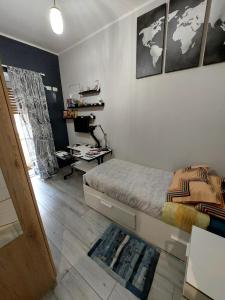 a bedroom with a bed and a desk in it at Marconi Rooms in Rome