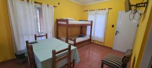 una habitación con mesa y sillas y una habitación con paredes amarillas en El Timbo en San José