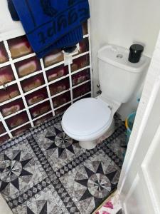 a bathroom with a toilet and a tiled floor at Freedom Boat in Naj‘ al ‘Amrāb