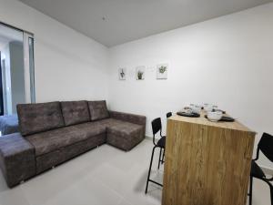 a living room with a couch and a table at Comic Homestay @ The Shore in Kota Kinabalu