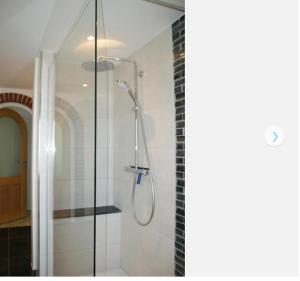 a shower with a glass door in a bathroom at Ferienwohnung-Auszeit in Hürup