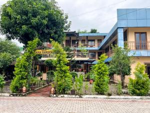a building with a garden in front of it at Ama Garden Sauraha in Sauraha