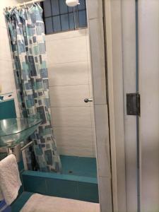 a bathroom with a shower with a sink and a mirror at Lugar cómodo y seguro in Lima