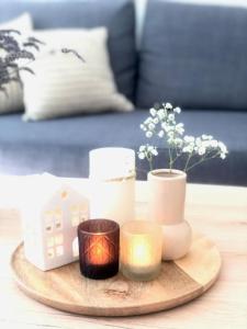 a wooden tray with candles and flowers on a table at Cozy Apartment in Hannover Central in Hannover