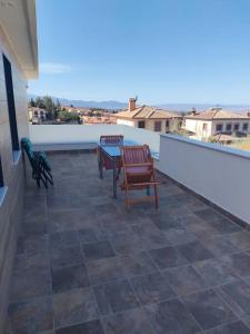 een patio met 2 stoelen en een tafel op een dak bij relax al pie de la alfaguara in Alfacar