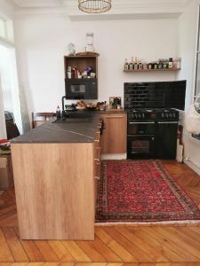 a kitchen with an island in the middle of a room at Home sweet home in Paris