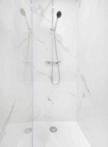 een badkamer met een douche en een glazen deur bij Appartement neuf • Cosy et Lumineux • 4 personnes in Marseille
