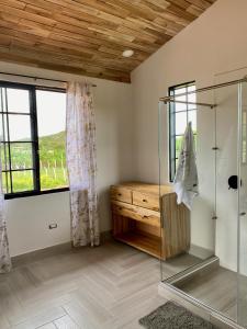 a bathroom with a glass shower and a window at Beautiful Private Villa, Views in Every Direction in Bolívar