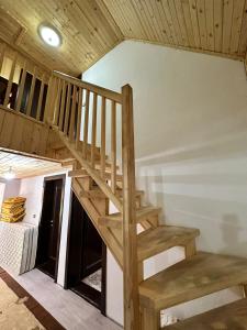 eine Holztreppe in einem Zimmer mit einer Decke in der Unterkunft Guest House Kukaj Valbone in Valbonë